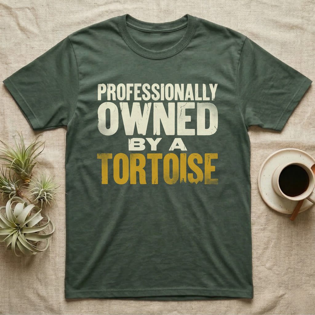 Owned By A Tortoise T-Shirt in Military Green — Distressed woodtype wordmark reading professionally owned by a tortoise in a bold two-tier lockup, text only.