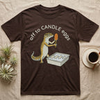 Leopard Gecko Candling T-Shirt in Dark Chocolate — Leopard gecko holding a torch under a glowing orange egg beside a tub of eggs, under the words off to CANDLE eggs