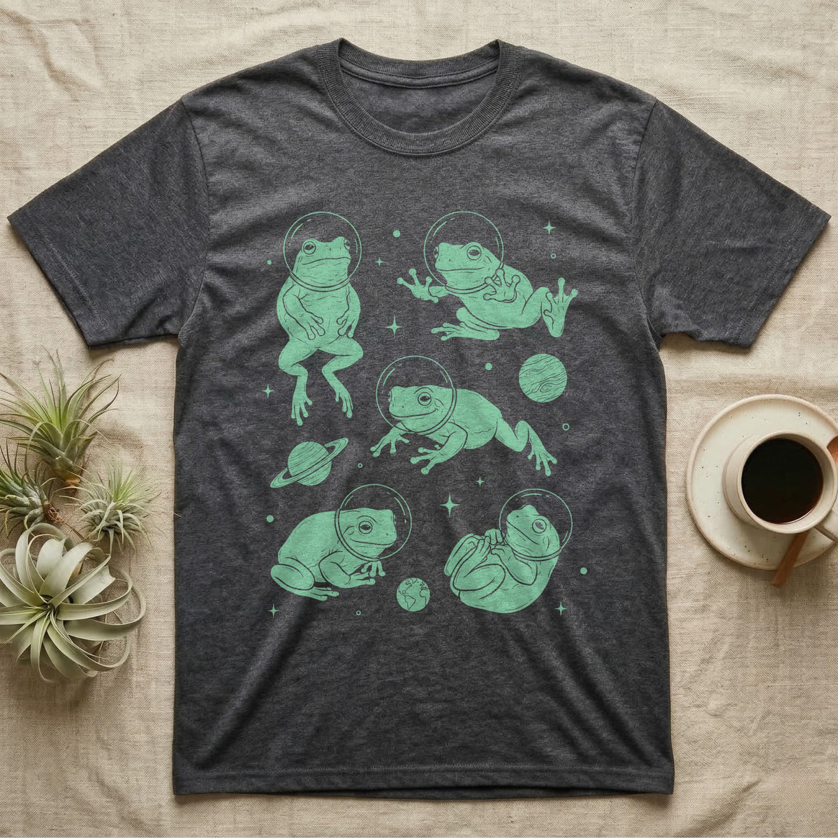 Whites Tree Frog Cosmic T-Shirt in Dark Heather — Vintage screen-print illustration of White's tree frogs in astronaut helmets floating in space, cosmic jade green monochromatic on dark background.