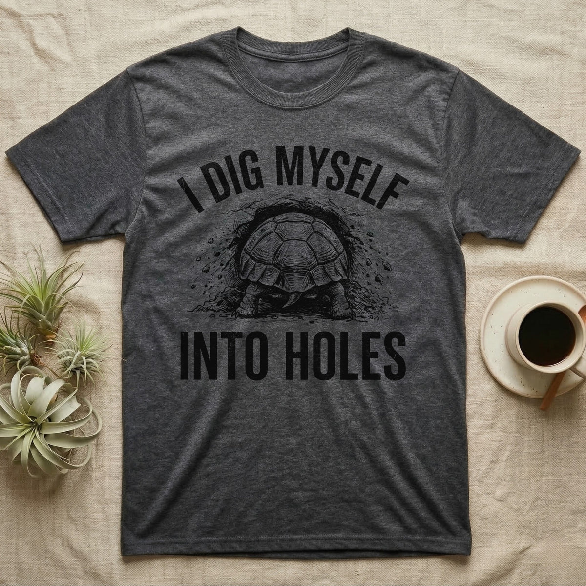 Russian Tortoise Digging T-Shirt in Dark Heather — Etched Russian tortoise digging headfirst into an earth bank, only its back end out, with the words I Dig Myself Into Holes