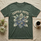 Tadpole Hotel Frog T-Shirt in Military Green — Whimsical naturalist illustration of a dart frog tucking tadpoles into a bromeliad Tadpole Hotel with hand-lettered marquee text.