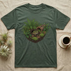 Pacman Frog Vivarium T-Shirt in Military Green — Botanical illustration of a pacman frog thriving in a planted bioactive vivarium beside a small empty plastic cup.