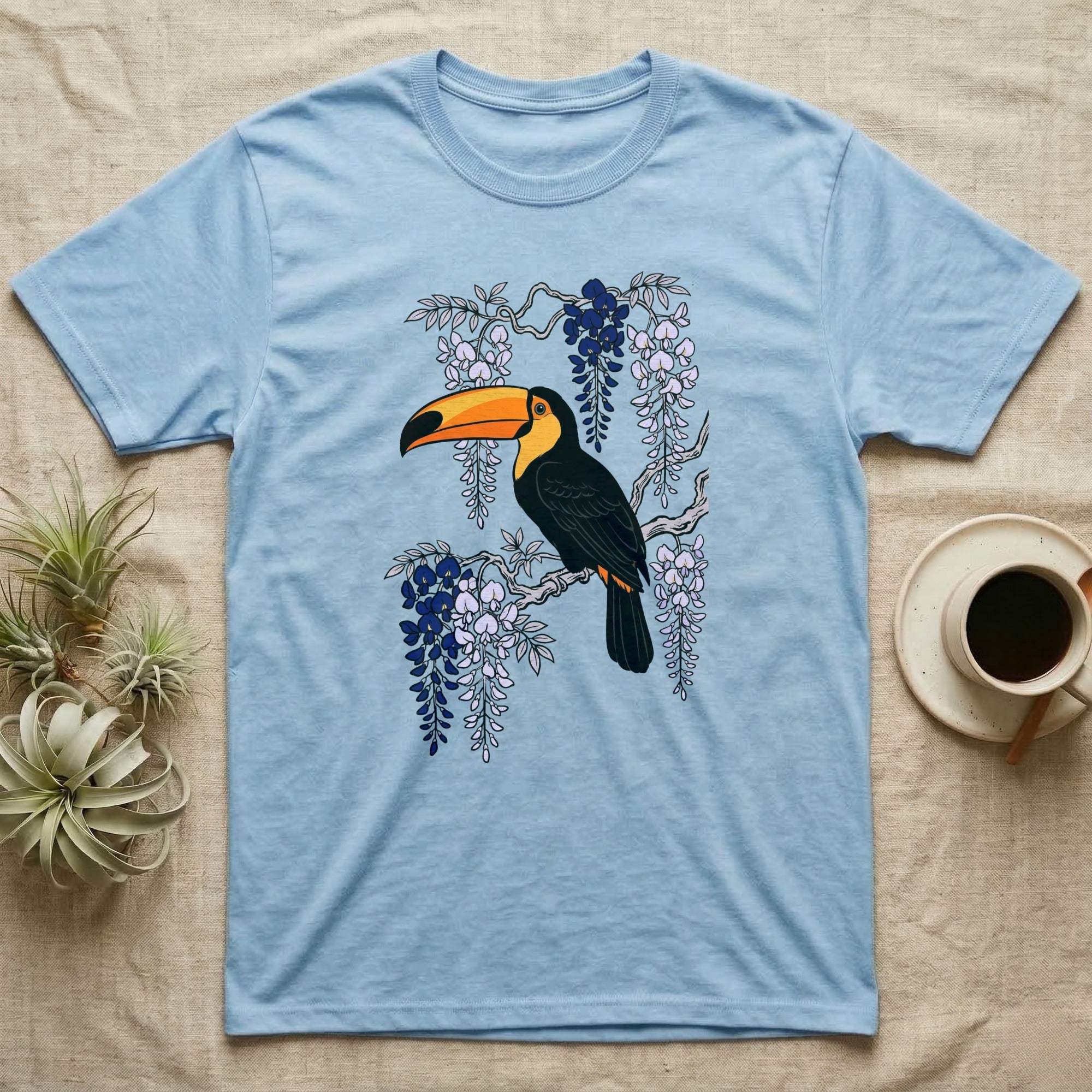 Light blue t-shirt with toucan on a flowering branch graphic.