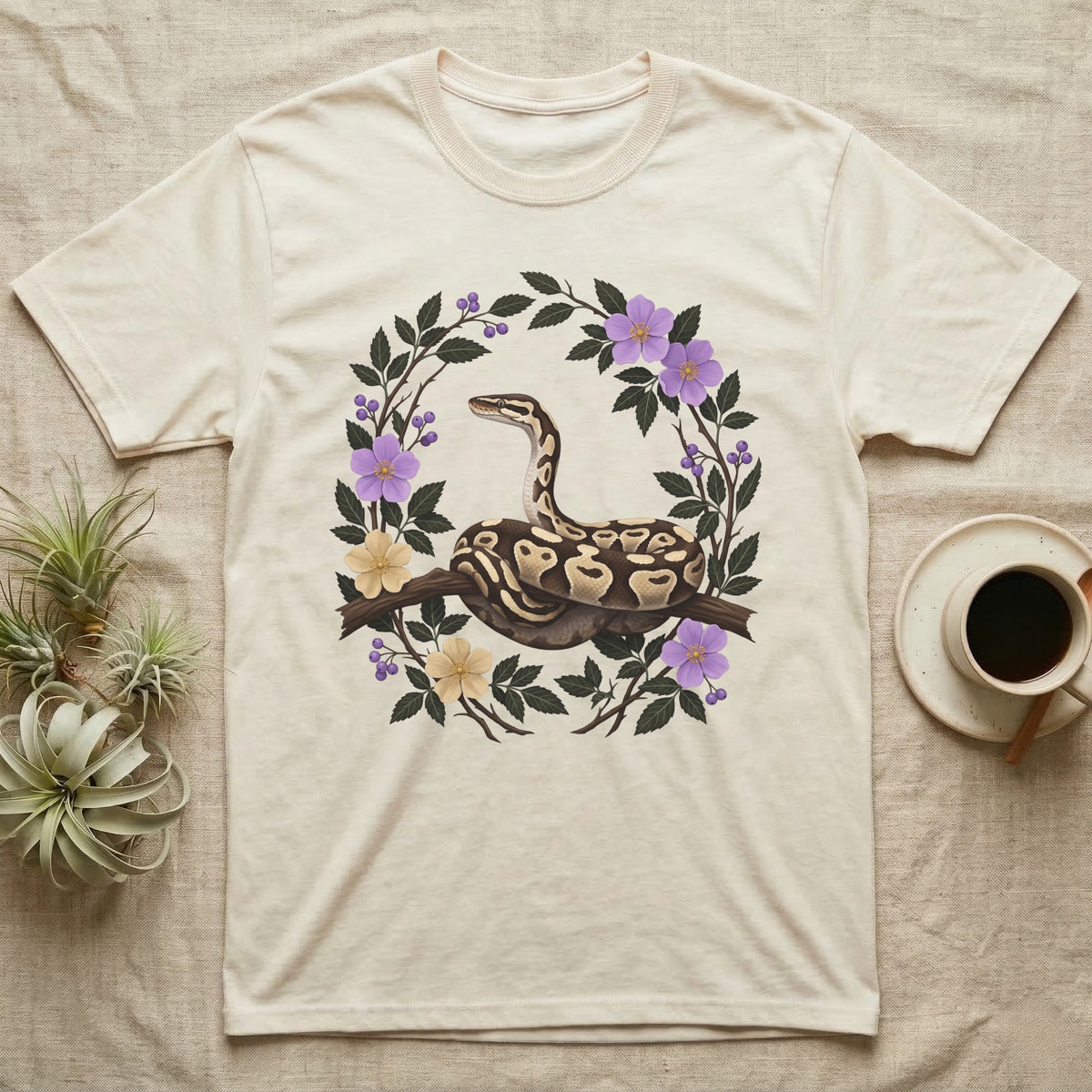 Ball Python Opinions Television T-Shirt in Natural — Oil-painted ball python coiled on a branch, enclosed by a dense oval bower of flowering bramble.