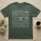 Terrarium Keeper One Tank T-Shirt in Military Green — White outline illustration of eleven terrarium species — bearded dragon, crested gecko, ball python, axolotl, tortoise, tarantula, isopod, whip spider, chameleon, tree frog and hognose — with pothos and fern leaves, ringed around the script line it started with one tank.