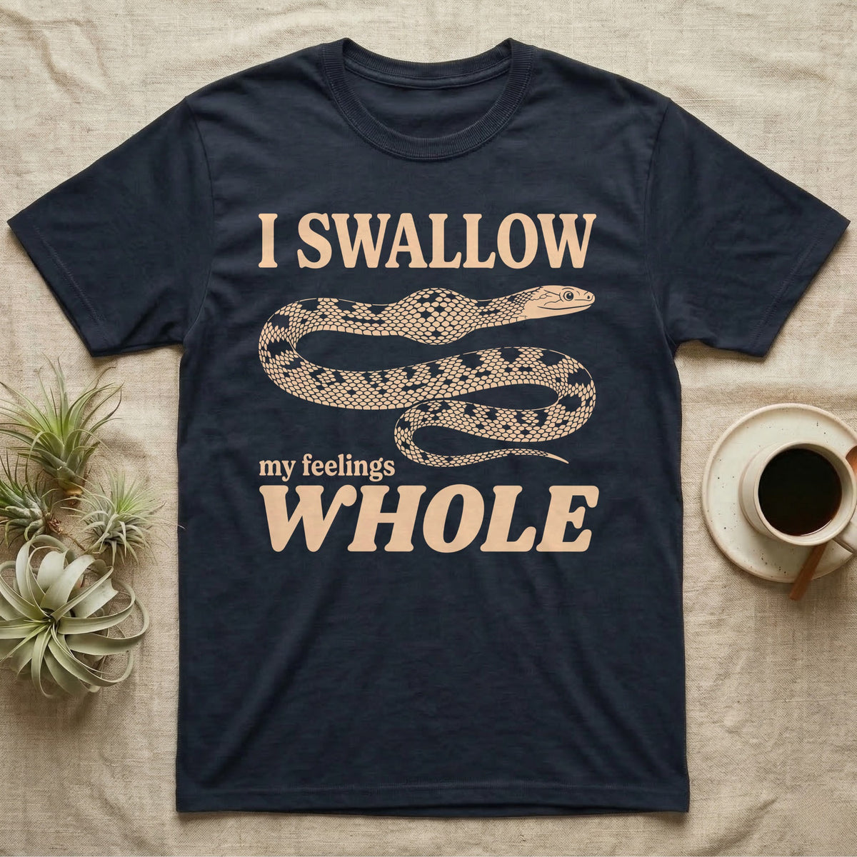Corn Snake Lump T-Shirt in Navy — Cream scale-mosaic corn snake on black with an oval bulge behind its neck under cream words: I SWALLOW my feelings WHOLE