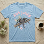 Pink Toe Tarantula Softie T-Shirt in Light Blue — Pink toe tarantula poised to leap on a branch under a puffy pastel "just jumpy" bubble wordmark with tiny hearts.