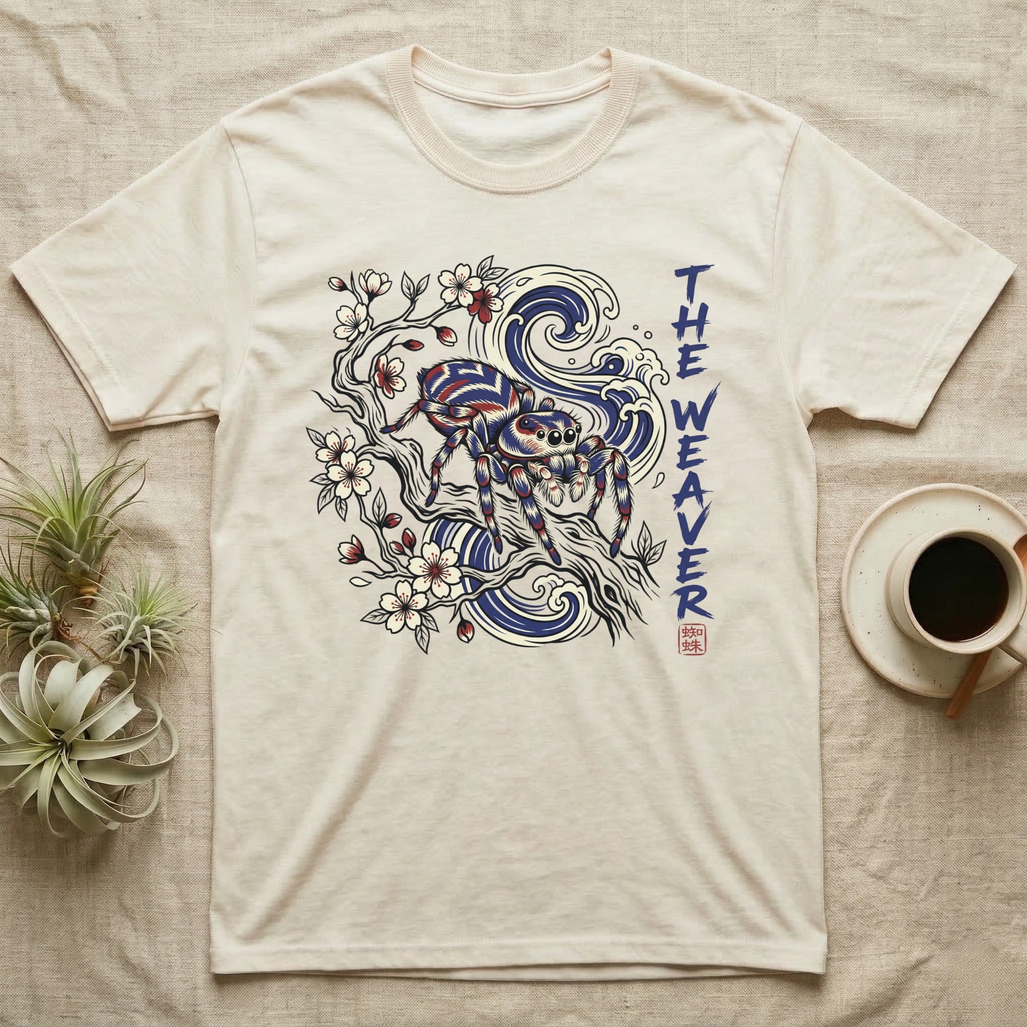 Cream t-shirt with a spider, branches, and waves design.
