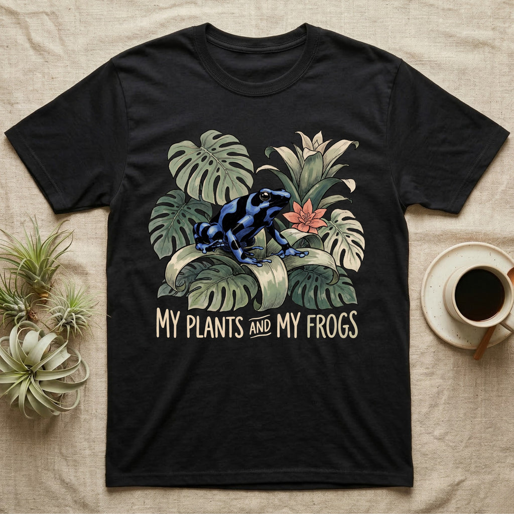 Plants And Frogs T-Shirt in Black — Naturalist-plate illustration of a dart frog perched in lush foliage with hand-lettered text reading My Plants And My Frogs.