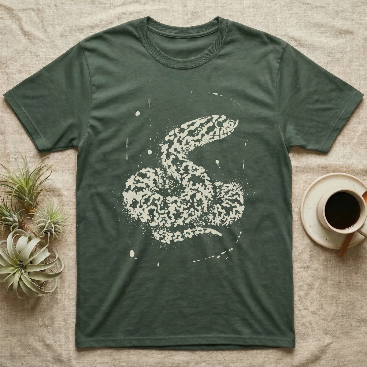 Hognose Bleach Spatter T-Shirt in Military Green — A western hognose snake formed from pale bleach spatter on a near-black ground, head turned to show its upturned snout.