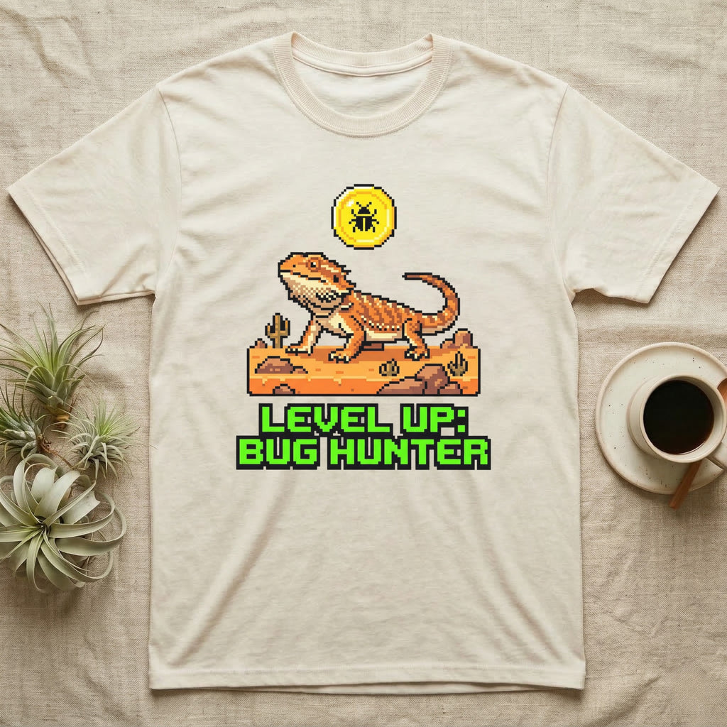 Cream t-shirt with pixel art of a bearded dragon and text "LEVEL UP: BUG HUNTER".