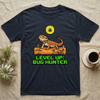 Dark t-shirt with pixelated bearded dragon, bug, and text "LEVEL UP: BUG HUNTER".