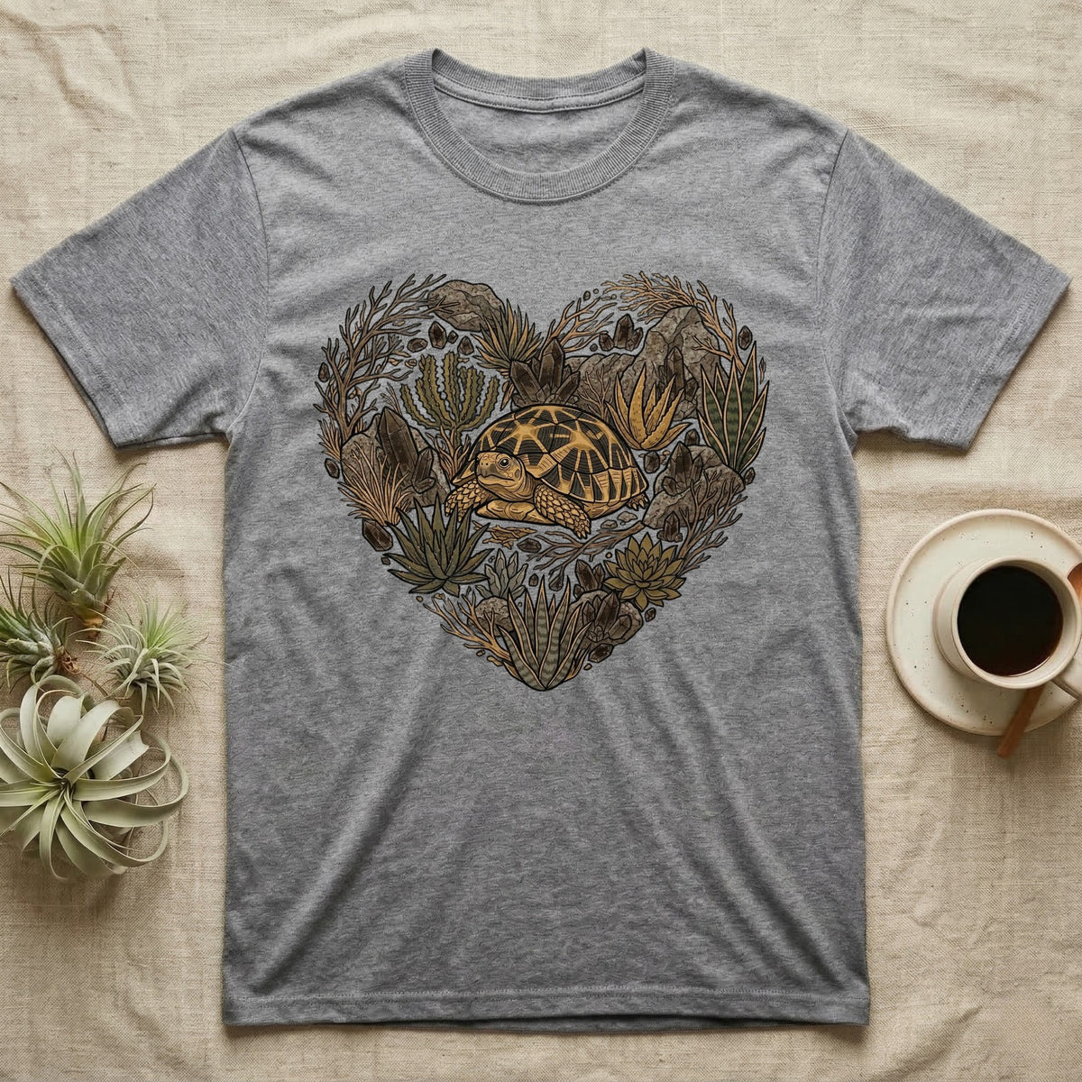 Grey t-shirt with heart-shaped botanical design featuring a tortoise.