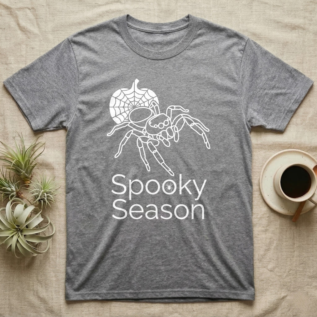 Jumping Spider Spooky Season T-Shirt in Sport Grey — Minimal continuous-line jumping spider over a spiderweb pumpkin, text "Spooky Season" with a spider in the O.