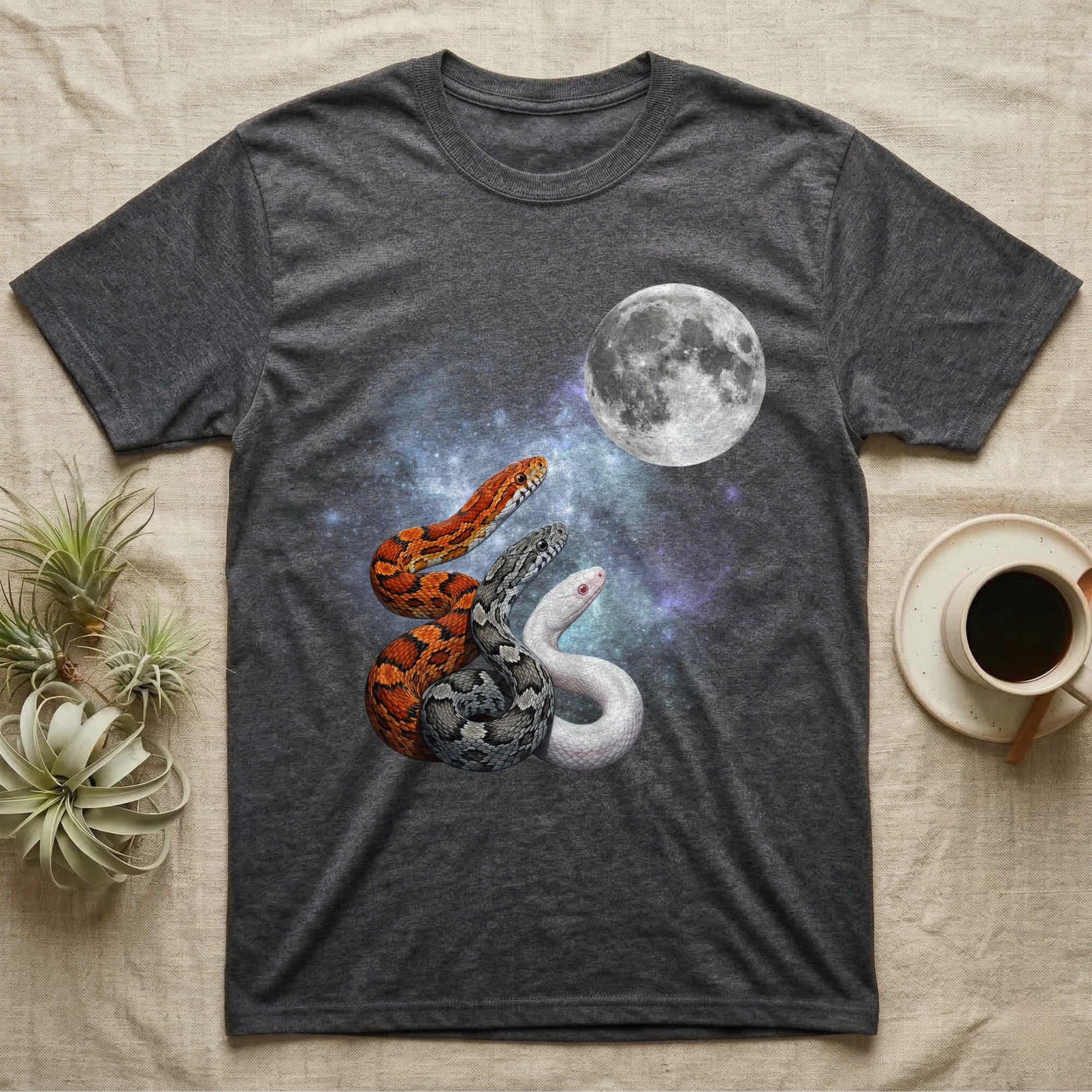 Corn Snake Moon Howl T-Shirt in Dark Heather — Three Corn Snake colour morphs howling at a full moon over a nebula on a dark grey t-shirt.