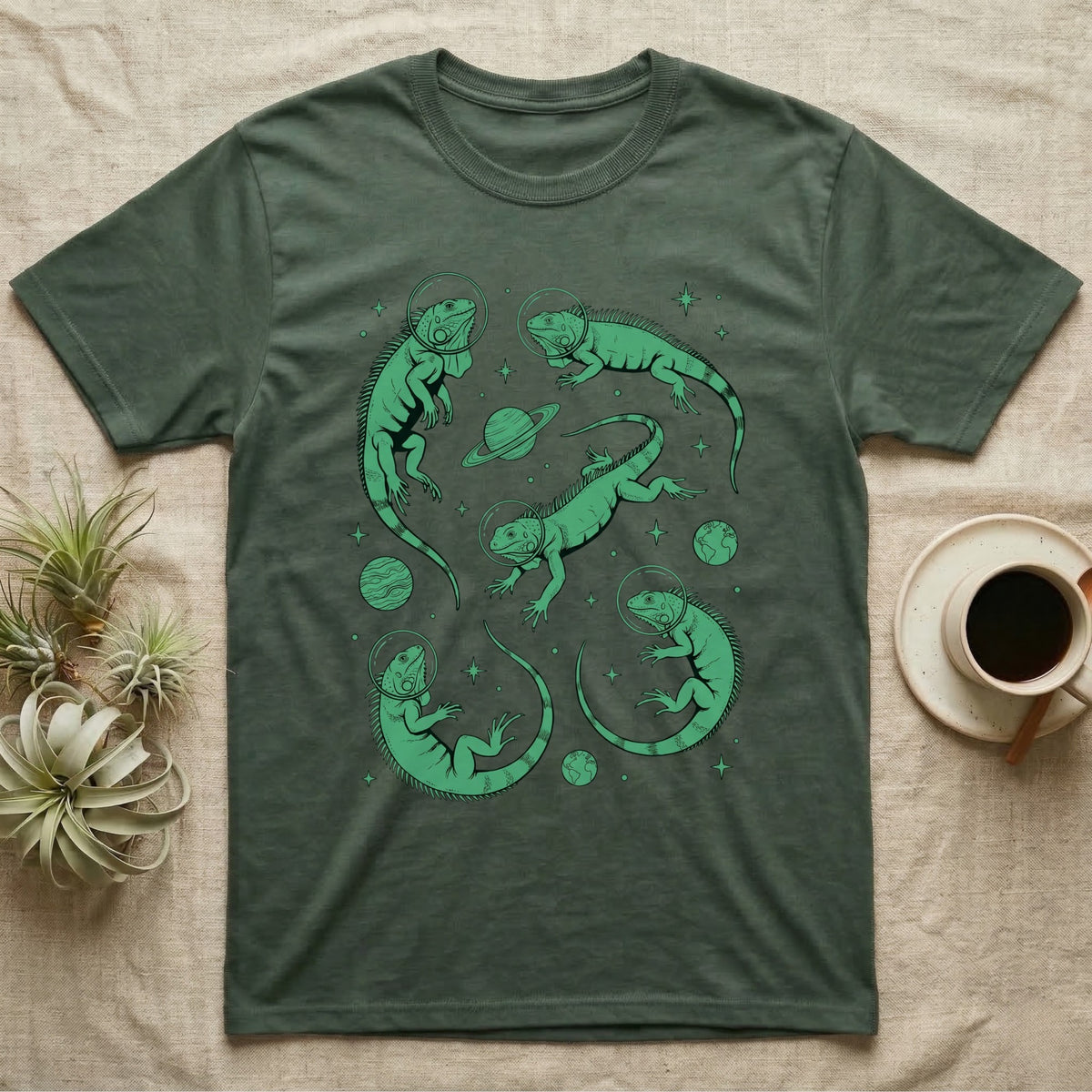 Green Iguana Cosmic T-Shirt in Military Green — Vintage screen-print illustration of green iguanas in astronaut helmets floating in space, cosmic emerald green monochromatic on dark background.