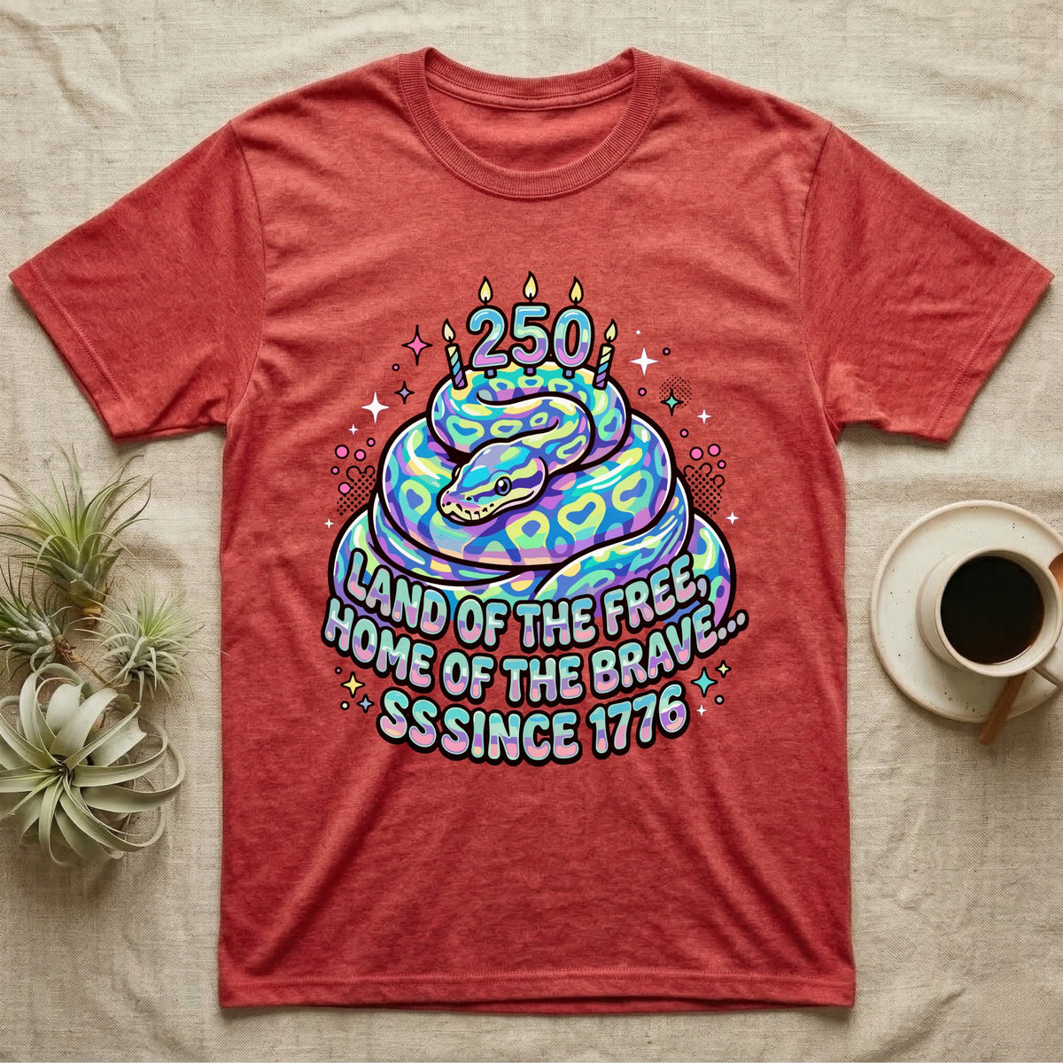 Ball Python Birthday Cake T-Shirt in Heather Red — Y2K pastel ball python coiled as a birthday cake with 250 candles and bubble text Land of the Free, Sssince 1776.