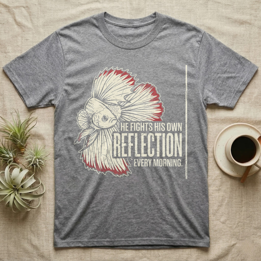 Betta Fights His Reflection T-Shirt in Sport Grey — Grunge-distressed betta in full flare display with red fin accents and type "He Fights His Own Reflection Every Morning."