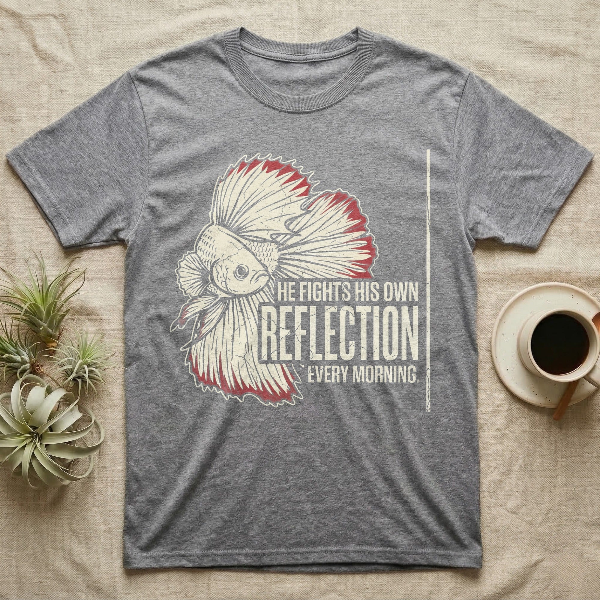 Betta Fights His Reflection T-Shirt in Sport Grey — Grunge-distressed betta in full flare display with red fin accents and type "He Fights His Own Reflection Every Morning."