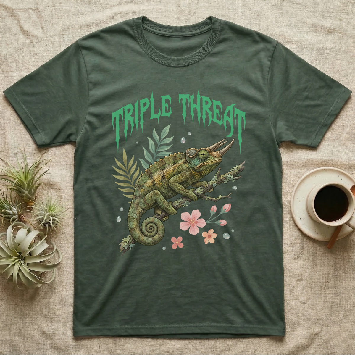 Jackson's Chameleon Feral T-Shirt in Military Green — Three-horned Jackson's chameleon on a branch below a dripping jade-green metal "Triple Threat" wordmark