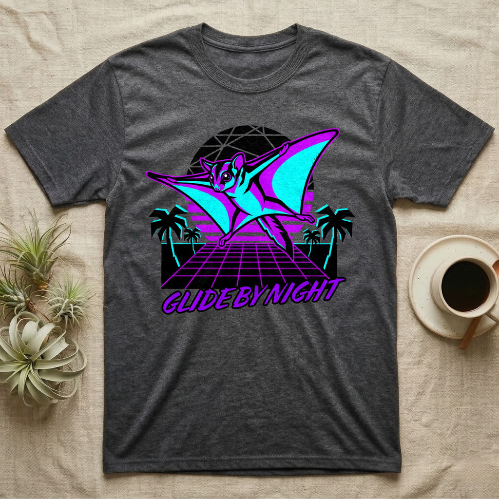 "Glide By Night" graphic tee featuring a neon flying squirrel in a retro sunset landscape.