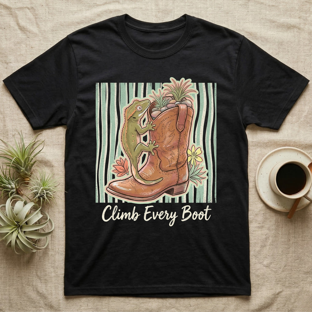 Black t-shirt with gecko and flowers climbing a cowboy boot with text "Climb Every Boot".