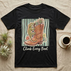 Black t-shirt with gecko and flowers climbing a cowboy boot with text "Climb Every Boot".