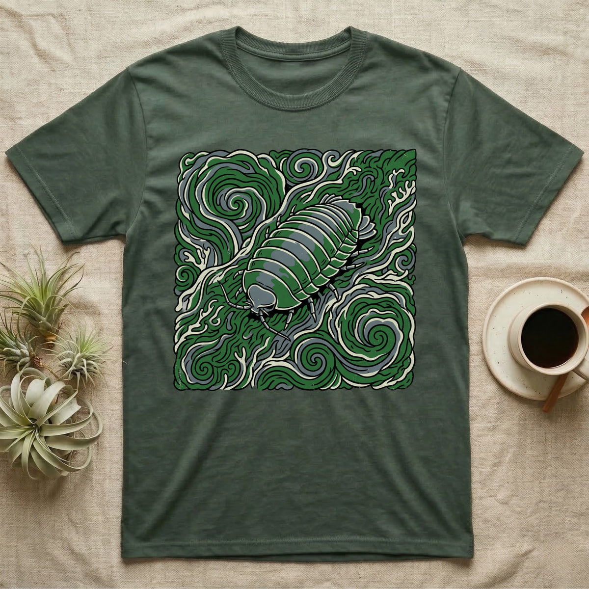 Green t-shirt with an illustration of a pill bug in a swirling pattern.