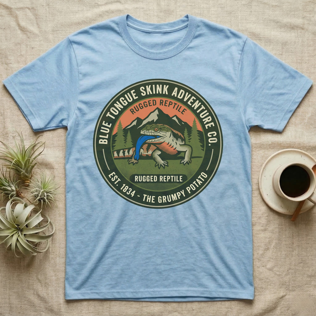 Light blue t-shirt with "Blue Tongue Skink Adventure Co." graphic and a lizard.