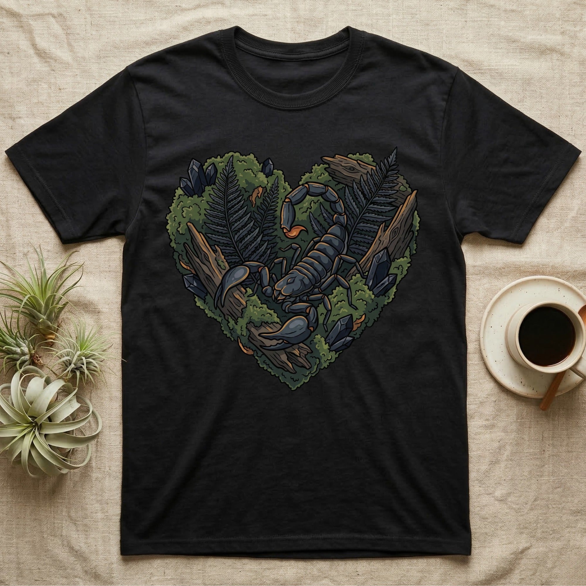 Black t-shirt with a heart-shaped design of a scorpion, ferns, and crystals.