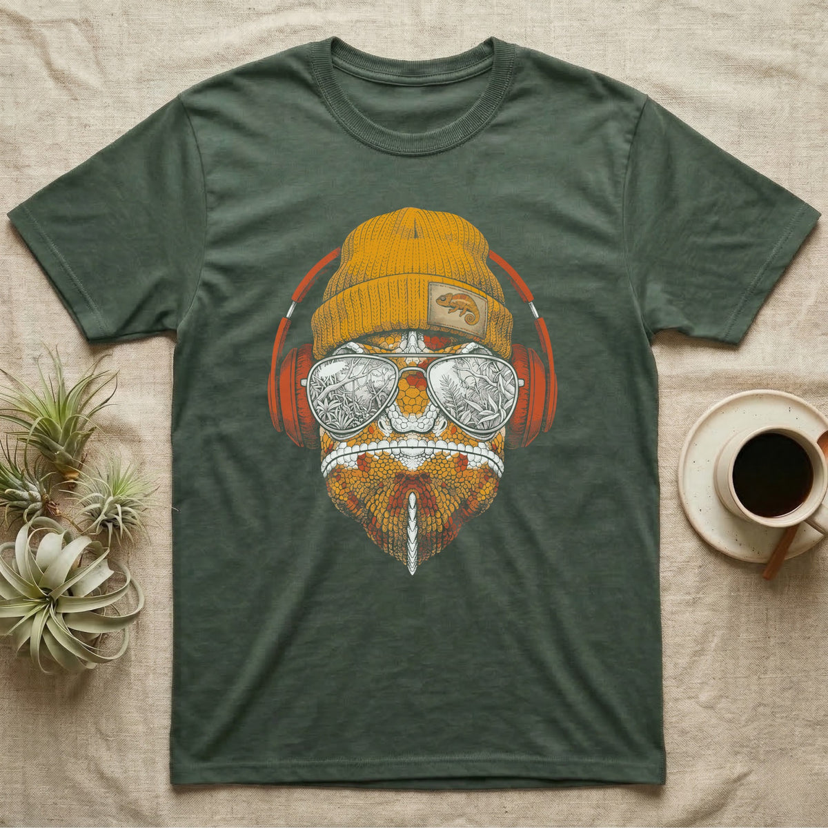Chameleon Chill Vibes T-Shirt in Military Green — Engraved chameleon with patterned orange skin in a beanie and headphones, aviators reflecting a jungle canopy.