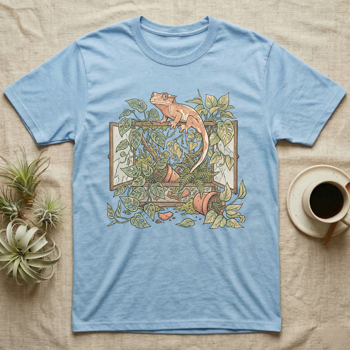 Bioactive Crested Gecko T-Shirt in Light Blue — Botanical illustration of a smug crested gecko perched atop a lush overgrown planted vivarium spilling vines.