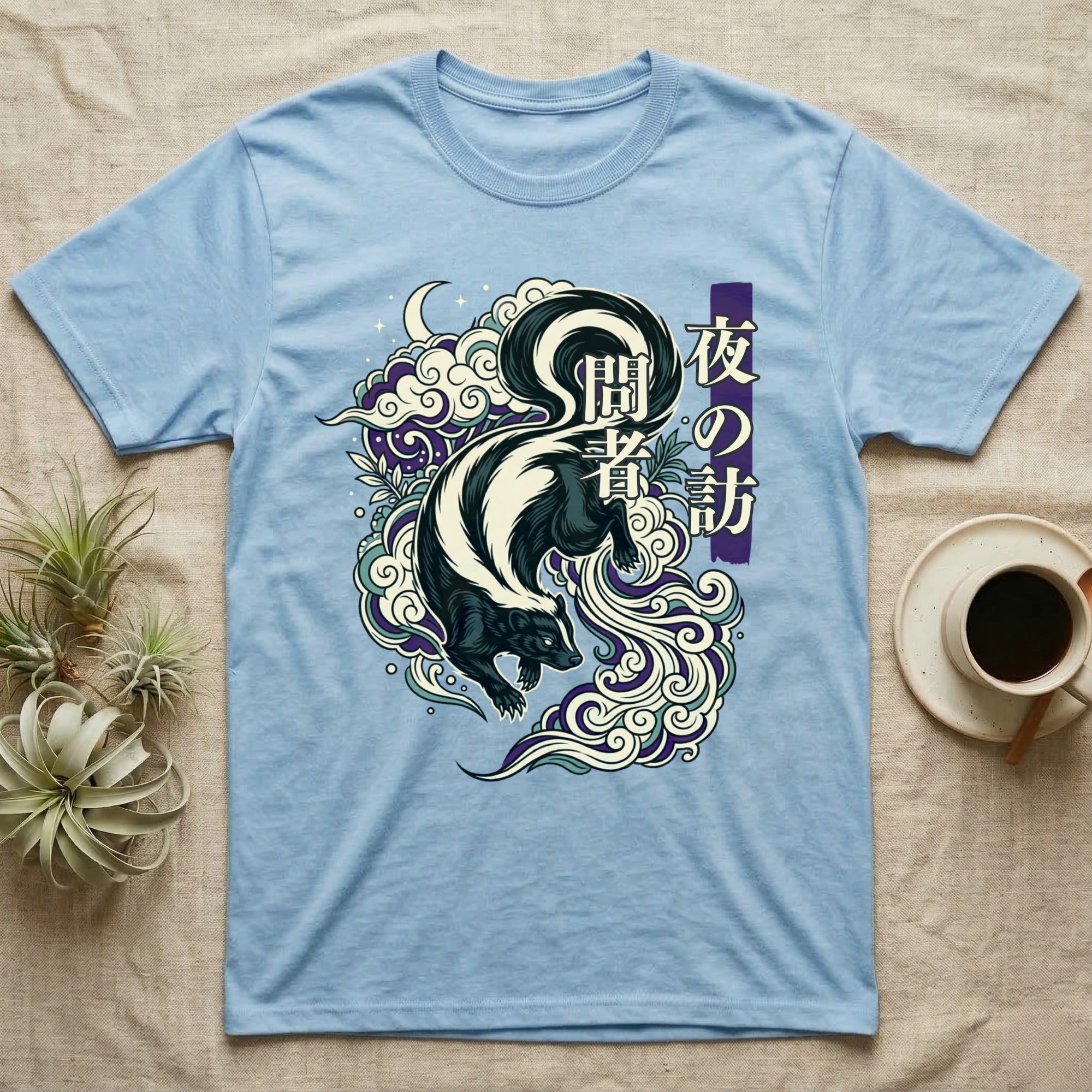 Light blue t-shirt with a skunk and Japanese text in a cloud design.