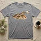 Ball Python Blossom T-Shirt in Sport Grey — Watercolor illustration of a tan-and-brown ball python holding an acacia blossom sprig, on a dark grey t-shirt.