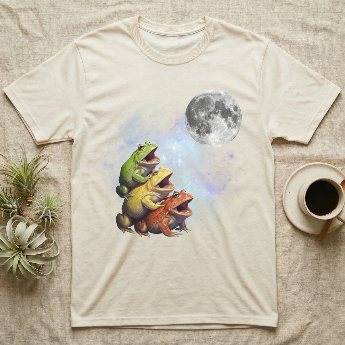 Pacman Frog Moon Howl T-Shirt in Natural — Three Pacman Frog colour morphs howling at a full moon over a nebula on a dark grey t-shirt.