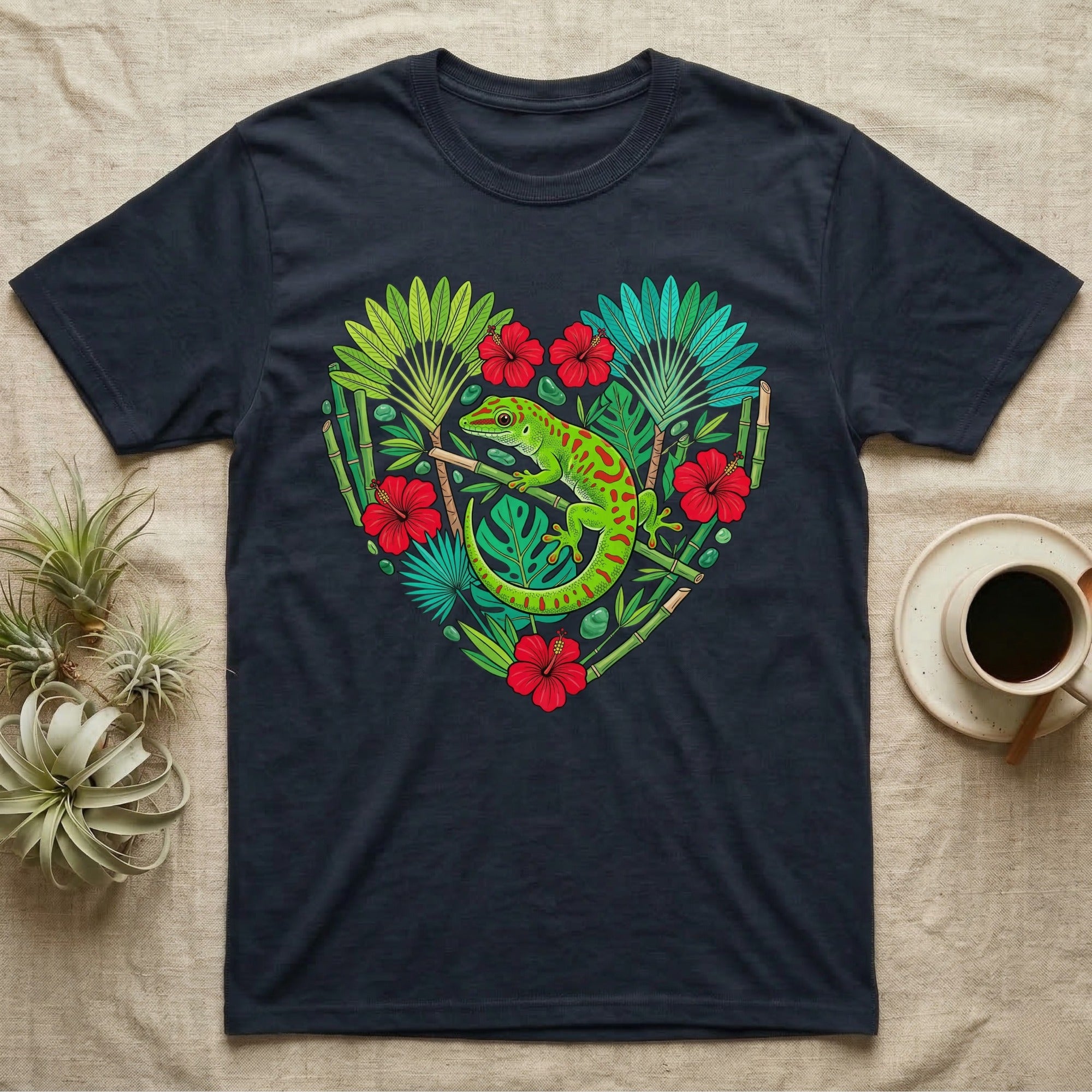 Dark t-shirt with green gecko and tropical leaves in a heart shape.