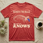 Blue-Tongue Skink Mood T-Shirt — Cream engraved blue-tongued skink on black flashing a cobalt blue tongue under the words WHEN I'M BLUE everyone KNOWS