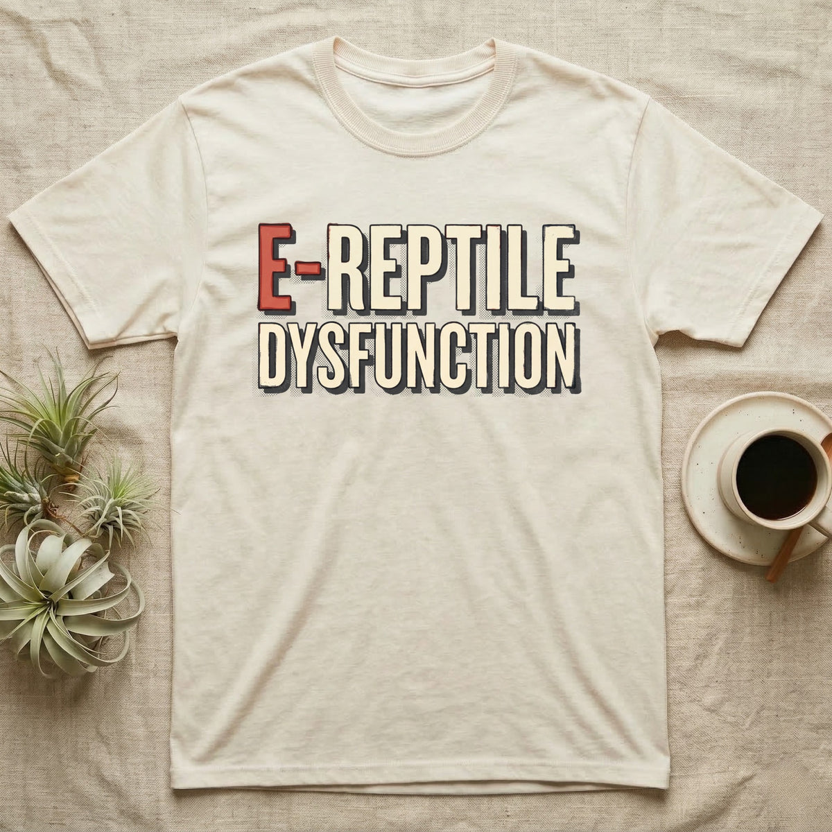 E-Reptile Dysfunction Gecko T-Shirt in Natural — Retro-pharmacy typographic wordmark reading "E-Reptile Dysfunction" in distressed cream and tomato-red lettering.