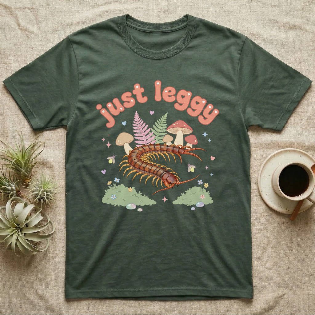 Vietnamese Centipede Baby T-Shirt in Military Green — Many-legged Vietnamese centipede curving among pastel ferns and toadstools under puffy coral text "just leggy".