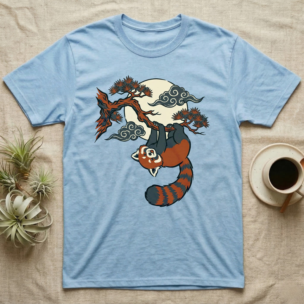 Light blue t-shirt with a red panda hanging from a tree branch under the moon.