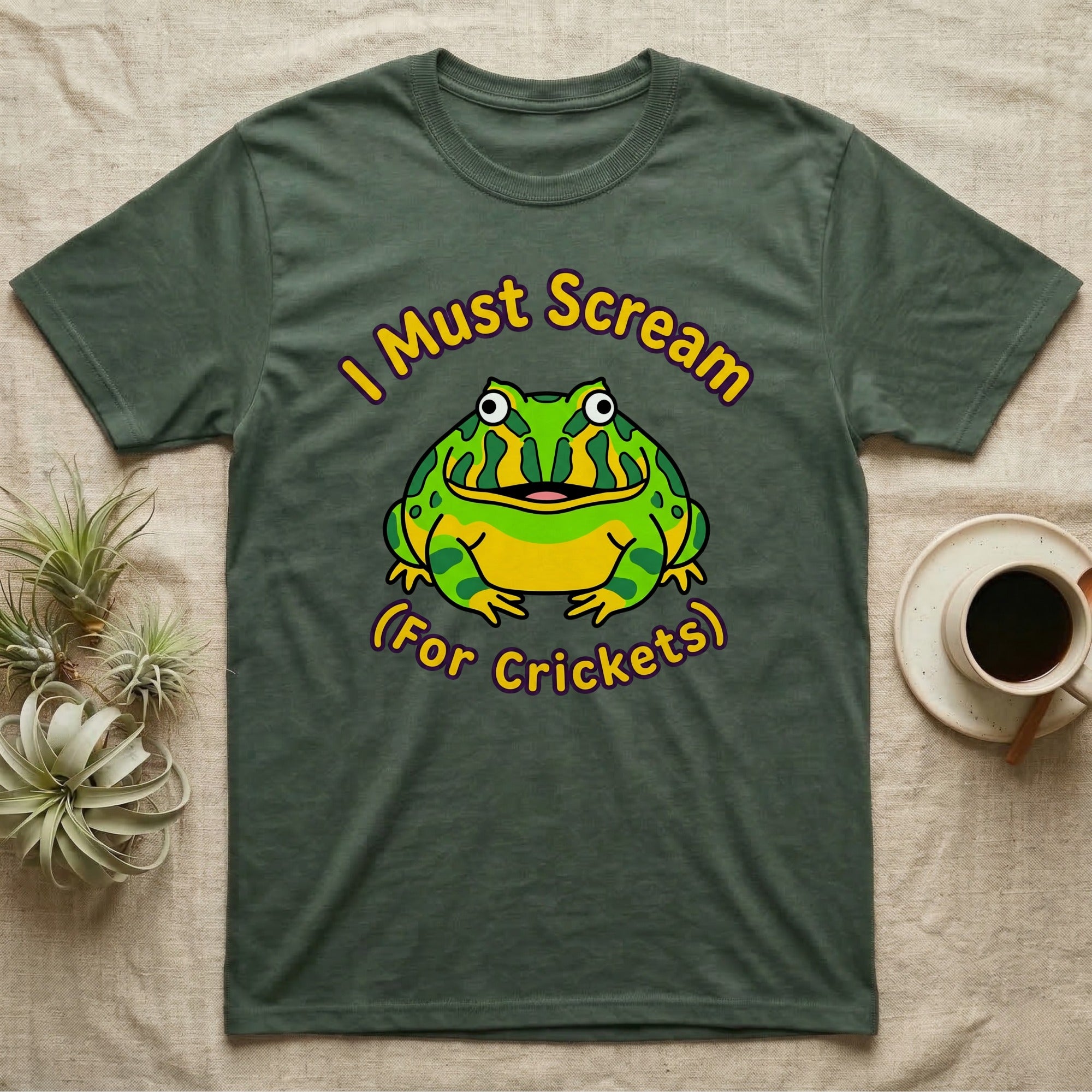 Green t-shirt with cartoon frog saying "I Must Scream For Crickets".