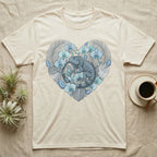 Cream t-shirt with a grey iguana surrounded by blue flowers and green leaves in a heart shape.