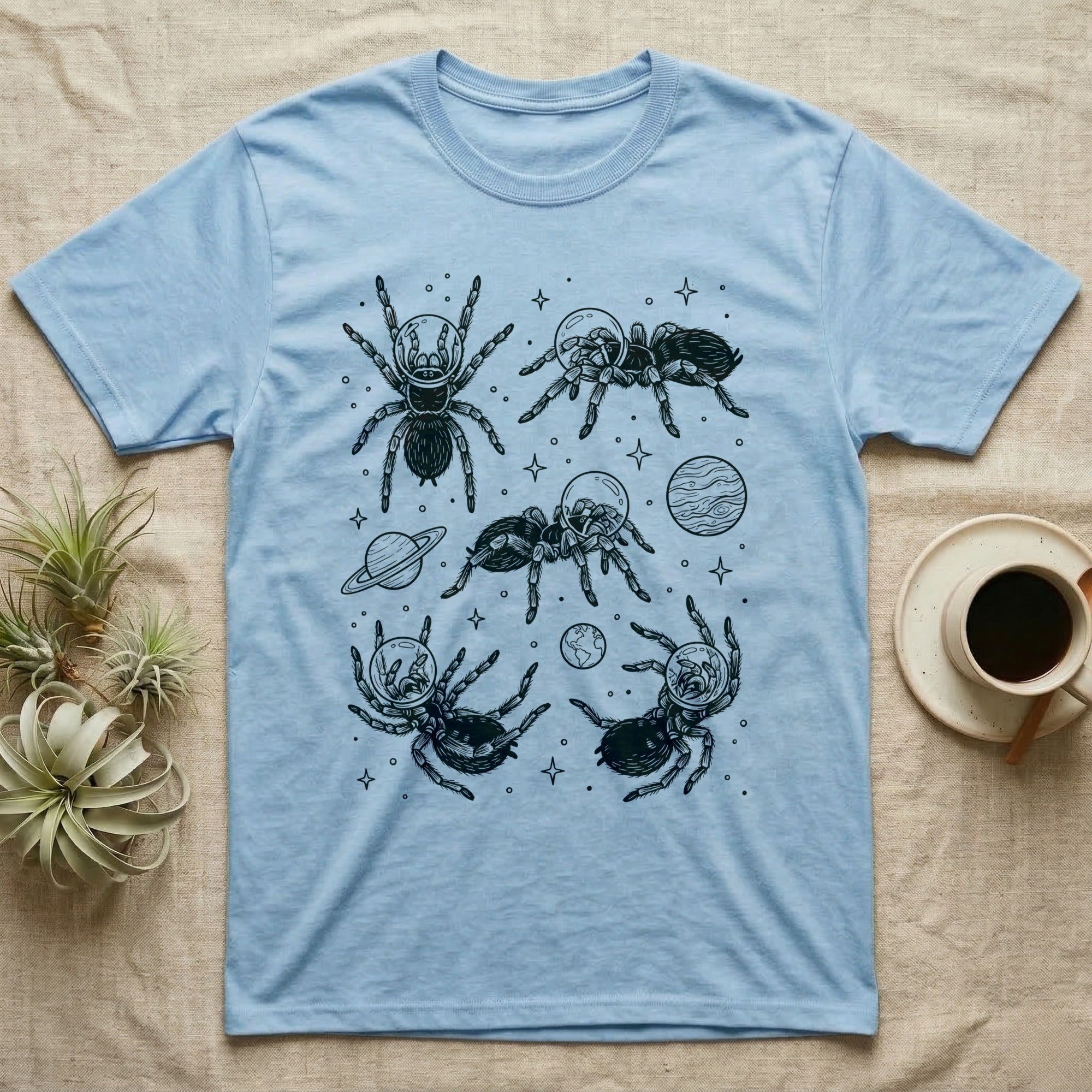 Tarantula Cosmic T-Shirt in Light Blue — Vintage screen-print illustration of tarantulas in astronaut helmets floating in space, obsidian black monochromatic on dark grey background.