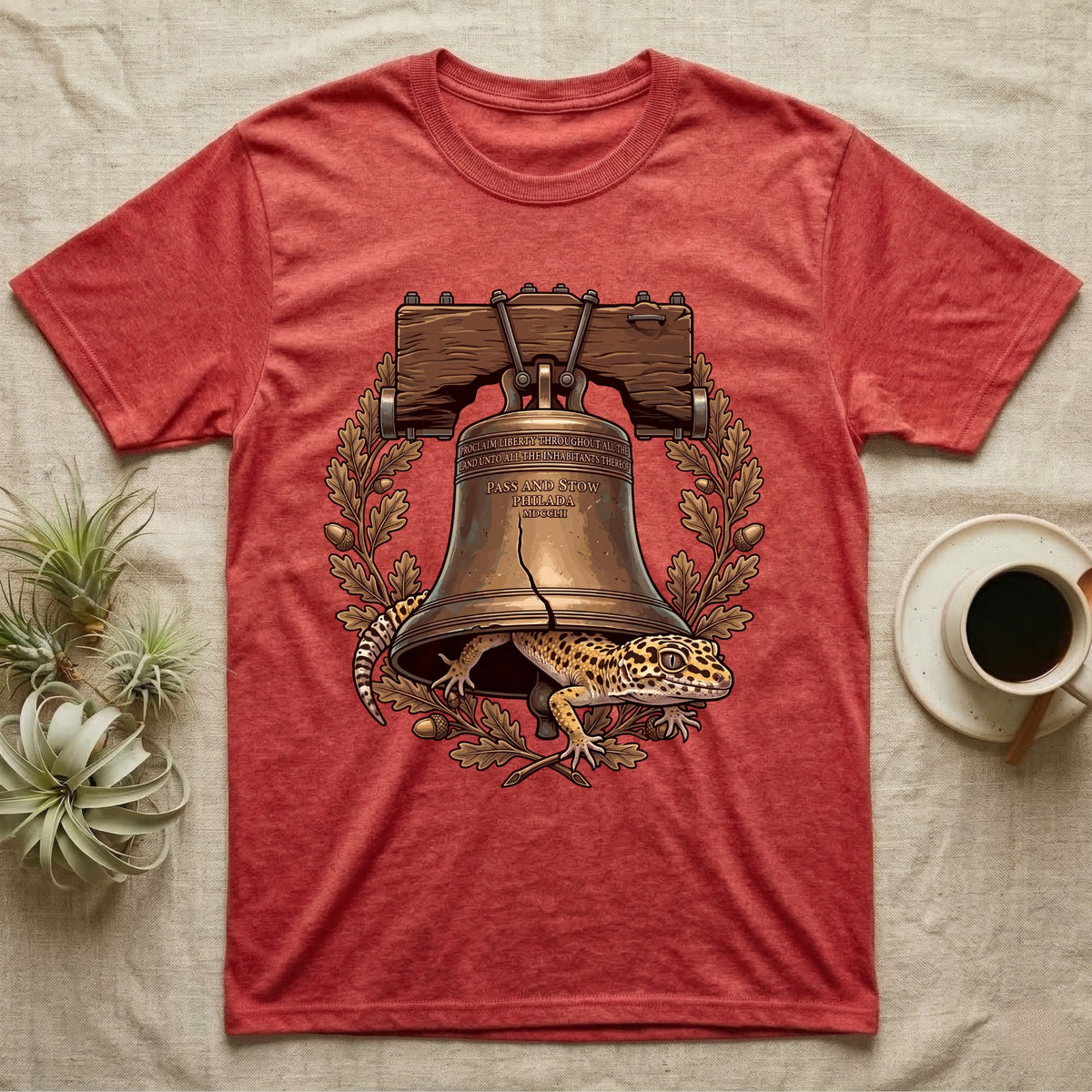 Leopard Gecko Liberty Bell T-Shirt in Heather Red — Engraved leopard gecko emerging beneath the bronze Liberty Bell inside an oak-leaf and acorn wreath.
