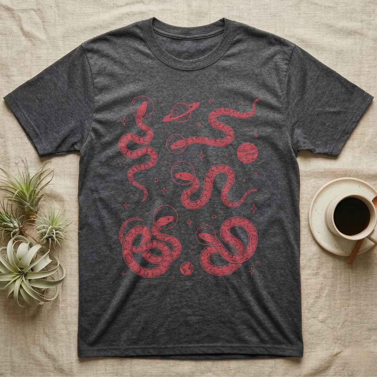 Corn Snake Cosmic T-Shirt in Dark Heather — Vintage screen-print illustration of corn snakes in astronaut helmets floating in space, cosmic crimson monochromatic on dark background.