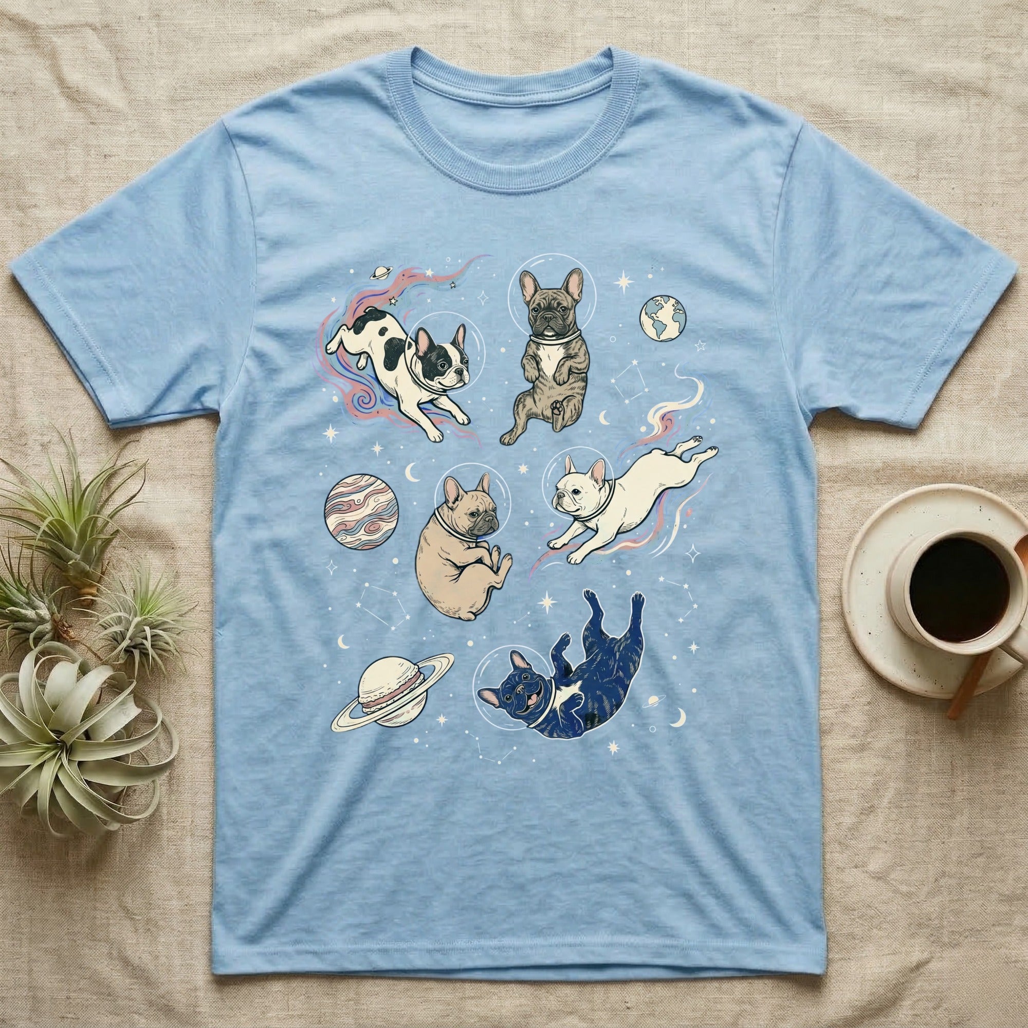 Light blue t-shirt with French bulldogs in space graphic.