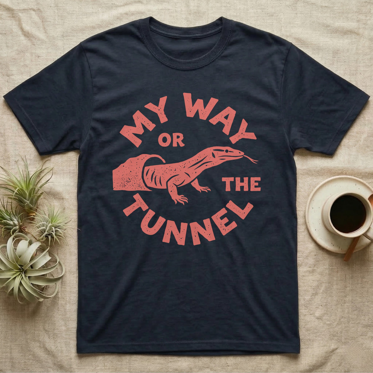 Ackie Monitor Tunnel T-Shirt in Navy — Carved one-ink badge of an ackie monitor emerging from its sand tunnel, tongue out, ringed by the words MY WAY OR THE TUNNEL