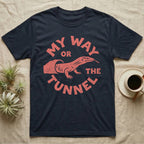 Ackie Monitor Tunnel T-Shirt in Navy — Carved one-ink badge of an ackie monitor emerging from its sand tunnel, tongue out, ringed by the words MY WAY OR THE TUNNEL