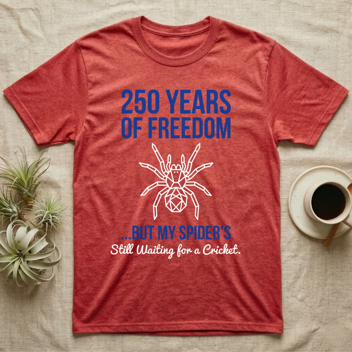 Tarantula Waiting For Cricket Tee in Heather Red — Minimalist geometric tee with a low-poly white tarantula and blue text reading 250 Years Of Freedom but my spider's still waiting for a cricket.