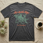 Fire-Bellied Toad Paradise T-Shirt in Dark Heather — Illustrated fire-bellied toad reclining in a beach chair with sunglasses and a cocktail, coral script reading Just Another Day In Paradise.